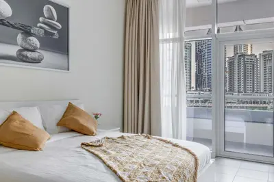 a bedroom with a bed with a view of a city at Knokey Bay Square in Dubai
