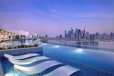 a hotel swimming pool with a view of a city at Chic Living 1 BHK with Beach Access in Dubai