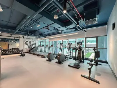 a gym with treadmills and elliptical machines at Chic Living 1 BHK with Beach Access in Dubai