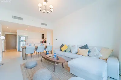 a living room with a couch and a table at Downtown Views Tower 2 brand new apt in Dubai