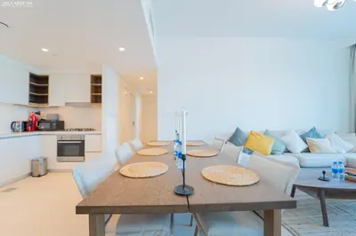 a dining room with a table and a couch at Downtown Views Tower 2 brand new apt in Dubai