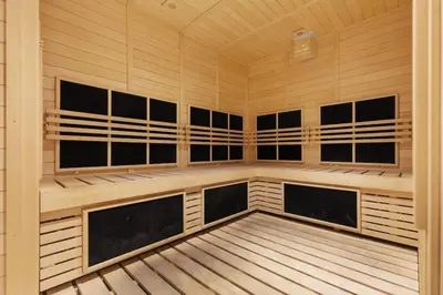 a sauna with wood paneling and a wooden floor at Waves - Fully Equipped Studio for a Perfect Stay in Dubai in Dubai