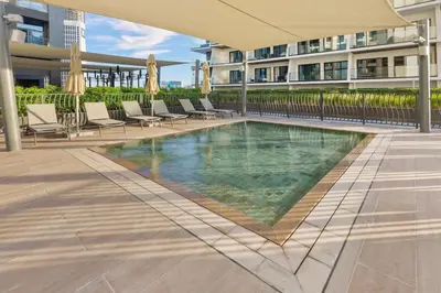 a swimming pool in the middle of a building at Waves - Fully Equipped Studio for a Perfect Stay in Dubai in Dubai