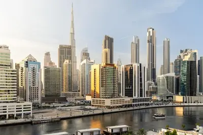 a city skyline with a river and buildings at Waves - Fully Equipped Studio for a Perfect Stay in Dubai in Dubai