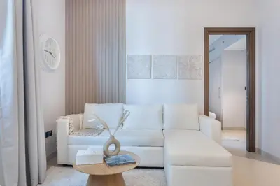 a living room with a white couch and a table at STAY BY LATINEM Luxury 2BR Holiday Home CV A813 near Burj Khalifa in Dubai