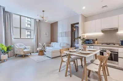 a kitchen and living room with a table and chairs at STAY BY LATINEM Luxury 2BR Holiday Home CV A813 near Burj Khalifa in Dubai