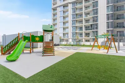 a playground in front of a tall building at STAY BY LATINEM Luxury 2BR Holiday Home CV A813 near Burj Khalifa in Dubai