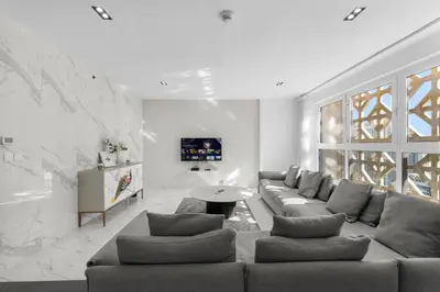 a living room with a couch and a table at Sea View apt in JBR - 2 BR in front of the beach in Dubai