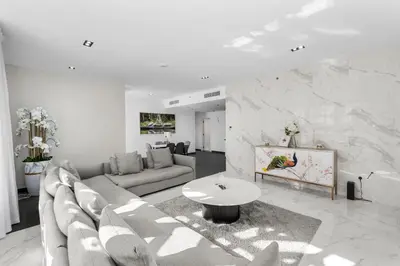 a living room with a couch and a table at Sea View apt in JBR - 2 BR in front of the beach in Dubai