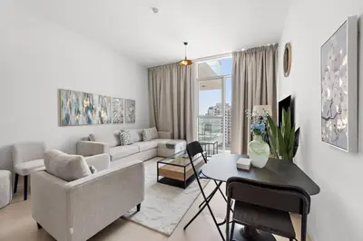 a living room with a couch and a table at Unique 1 BHK Near To Metro in Dubai