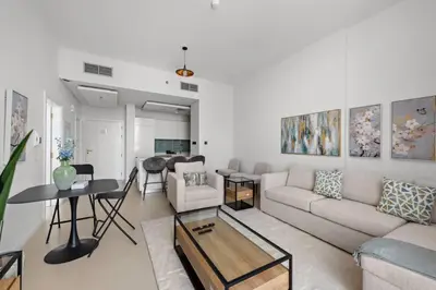 a living room with a couch and a table at Unique 1 BHK Near To Metro in Dubai