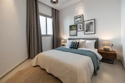 a bedroom with a large bed and a window at 2BR API 1000 Community View Jumeirah in Dubai