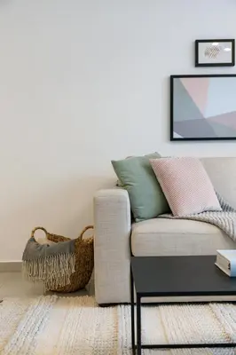 a living room with a couch and a table at 2BR API 1000 Community View Jumeirah in Dubai