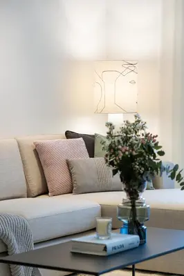 a living room with a couch and a coffee table at 2BR API 1000 Community View Jumeirah in Dubai