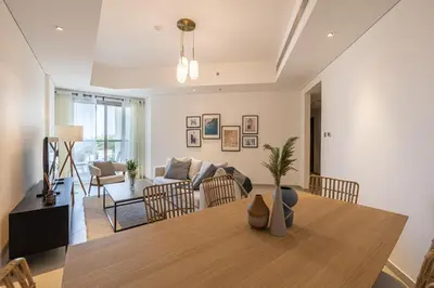 a living room with a table and a couch at 2BR API 1000 Community View Jumeirah in Dubai