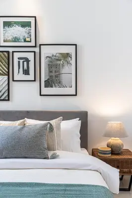 a bedroom with a bed and framed pictures on the wall at 2BR API 1000 Community View Jumeirah in Dubai