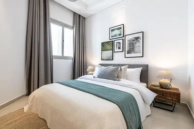 a bedroom with a large bed and a window at 2BR API 1000 Community View Jumeirah in Dubai