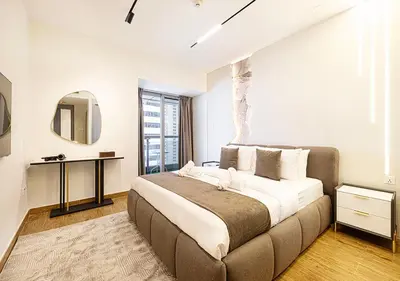 a bedroom with a large bed and a mirror at Coastal Marina Escape - 4 BR Sea, Dubai Eye & Palm View in Dubai