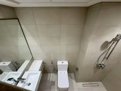 a bathroom with a sink and a toilet and a shower at Chic and Cozy Studio in Dubai