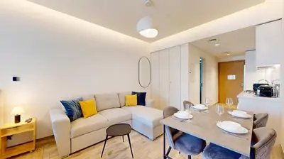 a living room with a couch and a table at Locations I Ahad Residences I Luxurious Studio Apartment I Business Bay I 10-Min Drive to Downtown Dubai & Burj Khalifa in Dubai