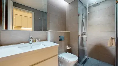 a bathroom with a toilet and a sink and a shower at Locations I Ahad Residences I Luxurious Studio Apartment I Business Bay I 10-Min Drive to Downtown Dubai & Burj Khalifa in Dubai