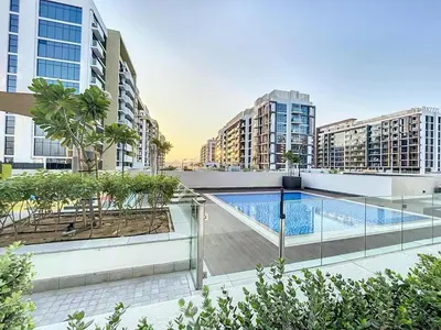 an apartment with a swimming pool on the roof of a building at Azizi Riviera 9 - Bright Studio in Meydan in Dubai
