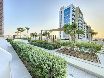 an exterior view of a building with trees and bushes at Azizi Riviera 9 - Bright Studio in Meydan in Dubai