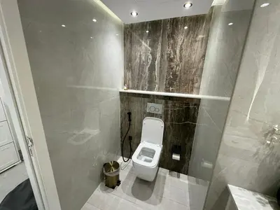 a bathroom with a white toilet in a stall at Lovely Brand new 3 BR with maids room in Dubai