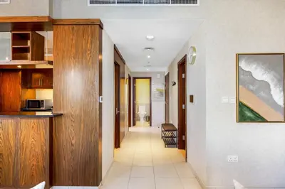 a hallway of a house with a kitchen and a living room at Durrani Homes - Lumina Grand 3BR with Burj khalifa and Fountain Views in Dubai