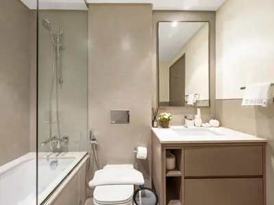 a bathroom with a toilet and a sink and a mirror at Grandeur 2 Bedroom Apartments I Burj Khalifa & Fountain Views I Free Parking, Gym, Pool, Wi-Fi & PS5 I by Skyline Serenity in Dubai