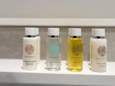 four bottles of liquids sitting on a shelf at Grandeur 2 Bedroom Apartments I Burj Khalifa & Fountain Views I Free Parking, Gym, Pool, Wi-Fi & PS5 I by Skyline Serenity in Dubai