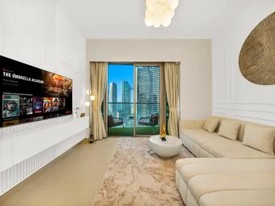 a living room with a couch and a tv at Grandeur 2 Bedroom Apartments I Burj Khalifa & Fountain Views I Free Parking, Gym, Pool, Wi-Fi & PS5 I by Skyline Serenity in Dubai