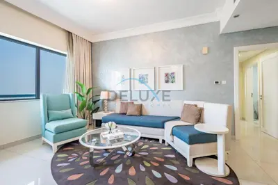 a living room with two chairs and a couch and a table at Lovely 2BR at The Signature, Downtown Dubai by Deluxe Holiday Homes in Dubai