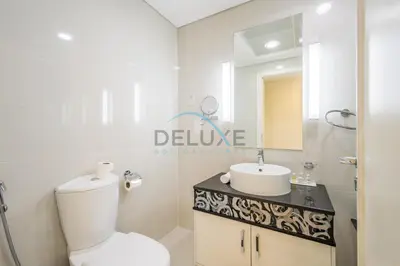 a white bathroom with a toilet and a sink at Lovely 2BR at The Signature, Downtown Dubai by Deluxe Holiday Homes in Dubai