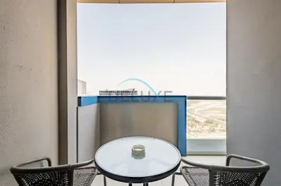 a table and chairs in a room with a window at Lovely 2BR at The Signature, Downtown Dubai by Deluxe Holiday Homes in Dubai