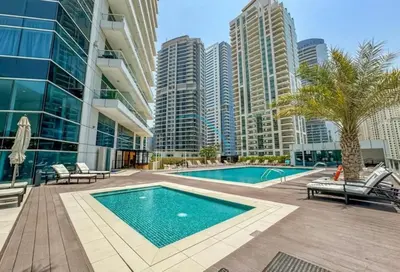 a swimming pool in the middle of a building at Stunning 1BR Apartment at Botanica Tower 1, Dubai Marina by Deluxe Holiday Homes in Dubai