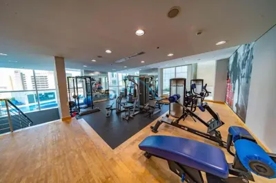 a gym with several treadmills and exercise bikes in it at Stunning 1BR Apartment at Botanica Tower 1, Dubai Marina by Deluxe Holiday Homes in Dubai