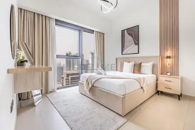 a bedroom with a large bed and a large window at Magnificent 2BR Apartment at Act One Act Two Tower 2 in Downtown Dubai by Deluxe Holiday Homes in Dubai