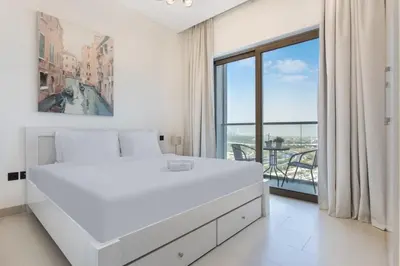 a white bedroom with a bed and a large window at STAY BY LATINEM Luxury 1BR Holiday Home CV B1311 near Burj Khalifa in Dubai