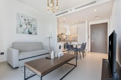 a living room with a couch and a table at STAY BY LATINEM Luxury 1BR Holiday Home CV B1311 near Burj Khalifa in Dubai