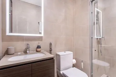 a bathroom with a toilet and a sink and a shower at STAY BY LATINEM Luxury 1BR Holiday Home CV B1311 near Burj Khalifa in Dubai
