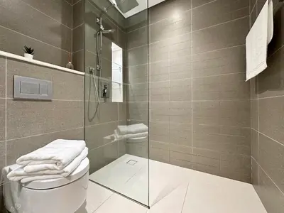 a bathroom with a glass shower and a toilet at Dubai Marina, LIV Residence, Luxury Studio Apartment in Dubai