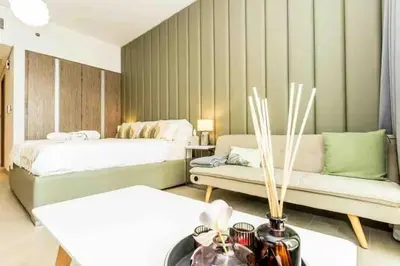 a hotel room with two beds and a couch at Dubai Marina, LIV Residence, Luxury Studio Apartment in Dubai