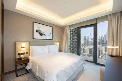 a bedroom with a large bed and a large window at Stunning Address Opera 3Bedroom in Dubai