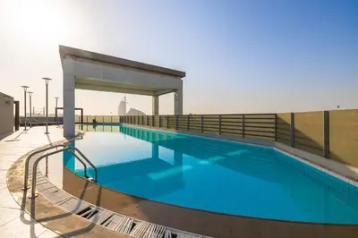 a swimming pool on the roof of a building at 2BR API 1000 Community View Jumeirah in Dubai