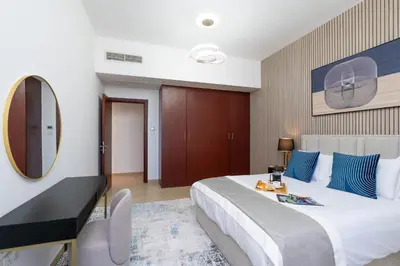 a bedroom with a large bed and a mirror at Breathtaking Scenery- JBR Walk- Beach Access in Dubai