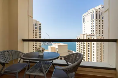 a table and chairs on a balcony with a view at Breathtaking Scenery- JBR Walk- Beach Access in Dubai
