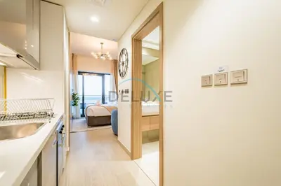 a kitchen and bathroom with a sink and a bed at Chic Studio in Azizi Riviera 44, Al Merkadh by Deluxe Holiday Homes in Dubai
