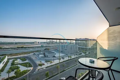 a balcony with a view of a city at Chic Studio in Azizi Riviera 44, Al Merkadh by Deluxe Holiday Homes in Dubai