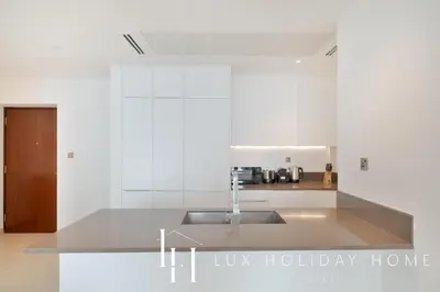 a kitchen with a sink and a counter top at LUX The Marina Gate Sea View Suite in Dubai